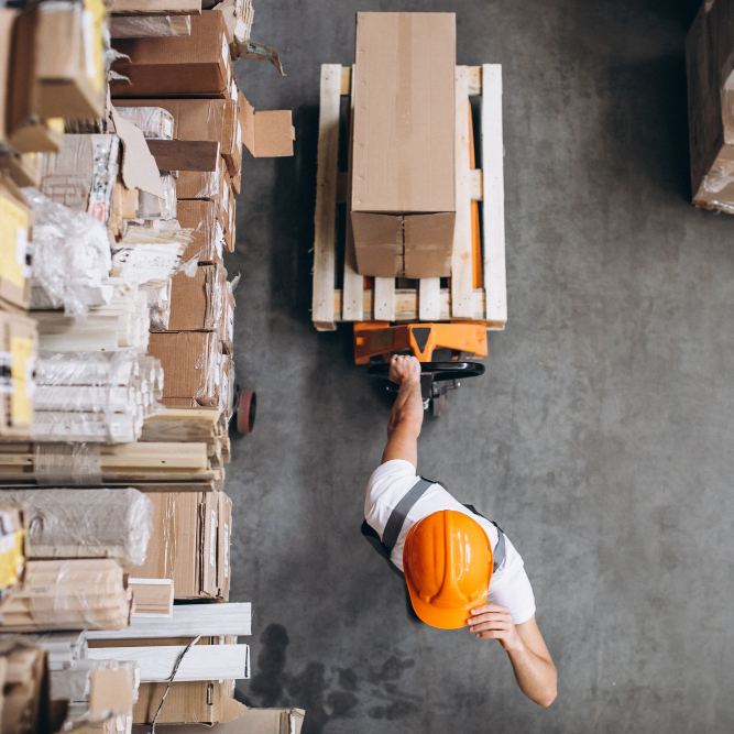 Warehouse worker doing logistics work with forklift loader